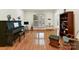 Bright living room with hardwood floors, piano, and built-in shelving at 8839 Blooming Arbor St, Huntersville, NC 28078