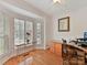 Home office with built-in desk and large window with plantation shutters at 8839 Blooming Arbor St, Huntersville, NC 28078