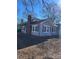 Side view of gray house with blue shutters, brick chimney, and landscaping at 924 E Main St, Albemarle, NC 28001