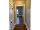 Hallway with hardwood floors and access to rooms at 924 E Main St, Albemarle, NC 28001