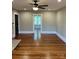 Living room with hardwood floors, ceiling fan, and view to another room at 924 E Main St, Albemarle, NC 28001