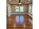 Living room with hardwood floors, ceiling fan and multiple windows at 924 E Main St, Albemarle, NC 28001