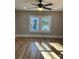 Living room with hardwood floors, ceiling fan and large window at 924 E Main St, Albemarle, NC 28001