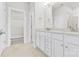Bright bathroom featuring double vanity, white cabinets, and neutral wall paint at 9307 Dufaux Dr, Charlotte, NC 28278