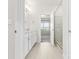 Bright bathroom featuring neutral tiling and a frameless glass shower door at 9307 Dufaux Dr, Charlotte, NC 28278