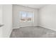 Well-lit bedroom with neutral carpeting and window at 9307 Dufaux Dr, Charlotte, NC 28278