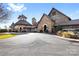 Beautiful exterior facade of clubhouse with stone and painted brick and well maintained grounds at 9307 Dufaux Dr, Charlotte, NC 28278
