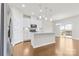 Modern kitchen featuring white cabinets, stainless steel appliances, and a center island at 9307 Dufaux Dr, Charlotte, NC 28278