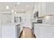 Modern kitchen with white cabinets, stainless steel appliances, and an island at 9307 Dufaux Dr, Charlotte, NC 28278