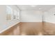 Large, bright living room with wood floors and plenty of natural light from the large windows at 9307 Dufaux Dr, Charlotte, NC 28278