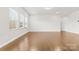 Spacious living room with hardwood floors and multiple windows at 9307 Dufaux Dr, Charlotte, NC 28278