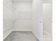 Walk-in closet with wire shelving and gray carpet flooring at 9307 Dufaux Dr, Charlotte, NC 28278