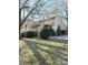 Tan two-story home with landscaping and trees in front at 1017 N Center Nw St, Hickory, NC 28601