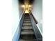 Staircase with carpeted steps and wooden handrail at 1017 N Center Nw St, Hickory, NC 28601