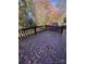 Wooden deck with fall leaves, overlooking a wooded backyard at 1024 Eaglewood Ave, Charlotte, NC 28212