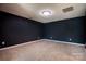 Finished basement room with dark walls and carpet at 105 Clarendon St # E, Mooresville, NC 28117