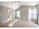 Main bedroom with vaulted ceilings, carpeting, and ample window light at 105 Clarendon St # E, Mooresville, NC 28117