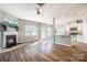 Spacious living room with hardwood floors, fireplace, and kitchen views at 105 Clarendon St # E, Mooresville, NC 28117