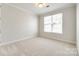 Simple bedroom with neutral carpeting and large window at 1056 Emory Ln, Fort Mill, SC 29708