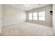 Well-lit bedroom featuring neutral walls and carpet at 1056 Emory Ln, Fort Mill, SC 29708