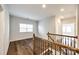 Upper level hallway with hardwood floors and an iron railing at 1056 Emory Ln, Fort Mill, SC 29708