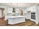 Modern kitchen with white cabinets, large island, and hardwood floors at 1056 Emory Ln, Fort Mill, SC 29708