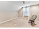 Bright bedroom with neutral walls, carpeting, and a rocking chair at 1115 Millview Ln, Matthews, NC 28104