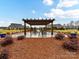 Relax under the pergola with seating and landscaping at 1115 Millview Ln, Matthews, NC 28104