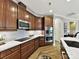 Modern kitchen with stainless steel appliances and wood cabinets at 1115 Millview Ln, Matthews, NC 28104