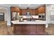 Modern kitchen with wood cabinets, large island, and stainless steel appliances at 1115 Millview Ln, Matthews, NC 28104