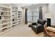 Study with built-in bookcases and comfortable armchair at 1115 Millview Ln, Matthews, NC 28104