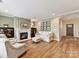 Living room with fireplace and hardwood floors, adjacent to entryway at 1115 Millview Ln, Matthews, NC 28104