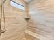 Walk-in shower with built-in bench and pebble floor at 1115 Millview Ln, Matthews, NC 28104