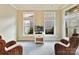 Cozy sitting room with two wicker chairs and a flat-screen TV at 1115 Millview Ln, Matthews, NC 28104