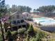 Aerial view of community pool and clubhouse with deck at 116 Van Gogh Trl, Mount Holly, NC 28120