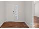 Bright entryway with hardwood floors and white door at 116 Van Gogh Trl, Mount Holly, NC 28120