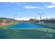 Community tennis court with lights and fencing at 116 Van Gogh Trl, Mount Holly, NC 28120