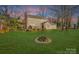 Spacious backyard with deck, fire pit, and mature trees at 13010 Marlstone Ln, Charlotte, NC 28215