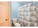 Light blue bathroom with a nautical shower curtain and toilet at 13010 Marlstone Ln, Charlotte, NC 28215