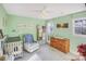 Bedroom with light green walls, crib, and plenty of storage at 13010 Marlstone Ln, Charlotte, NC 28215