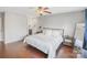 Main bedroom with hardwood floors, large bed, and en-suite bathroom at 13010 Marlstone Ln, Charlotte, NC 28215