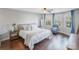 Main bedroom with hardwood floors, large bed, and bay windows at 13010 Marlstone Ln, Charlotte, NC 28215