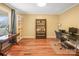 Home office featuring hardwood floors, built-in shelving, and a desk at 13010 Marlstone Ln, Charlotte, NC 28215