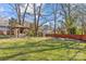 Spacious backyard with a pergola, fire pit, and lush lawn at 1334 Woodland Dr, Charlotte, NC 28205