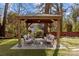 Relaxing backyard patio with pergola, seating, and stone pavers at 1334 Woodland Dr, Charlotte, NC 28205