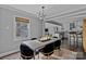 Bright dining room features a large table, modern chairs, and an open view to the kitchen at 1334 Woodland Dr, Charlotte, NC 28205