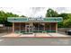 Lang Van restaurant building for sale. Features a green awning and ample parking at 1334 Woodland Dr, Charlotte, NC 28205