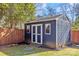 Blue storage shed with double doors and windows at 1334 Woodland Dr, Charlotte, NC 28205