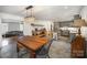 Open concept kitchen with gray cabinets, a large island, and dining area at 1346 5Th Street Nw Cir, Hickory, NC 28601