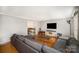 Living room features hardwood floors, sectional sofa, and a view into the dining area at 1346 5Th Street Nw Cir, Hickory, NC 28601